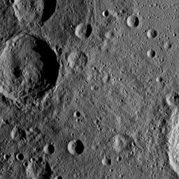 Sintana Crater is seen on the left side of this image of Ceres from NASA's Dawn spacercraft. The crater's central peak casts a shadow over its western flank. At lower right, the rim of Darzamat peeks into view.