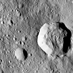 Ceres' surface shows evidence for different types of flows that indicate the presence of ice in the regolith. One type of flow encircles the large impact crater at right in this image taken by NASA's Dawn spacecraft.