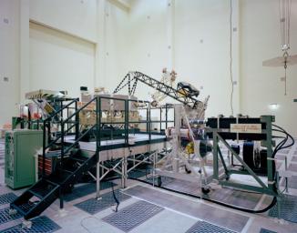 This archival photo shows the system test configuration for NASA's Voyager on October 1, 1976. The spacecraft's 10-sided bus is visible behind the catwalk railing in the foreground.