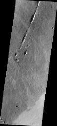 This image captured by NASA's 2001 Mars Odyssey spacecraft shows a collapse feature on the southeastern flank of Mars' Ascraeus Mons.
