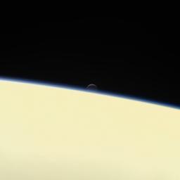 Saturn's active, ocean-bearing moon Enceladus sinks behind the giant planet in a farewell portrait from NASA's Cassini spacecraft. This view of Enceladus was taken by the Cassini spacecraft on Sept. 13, 2017.