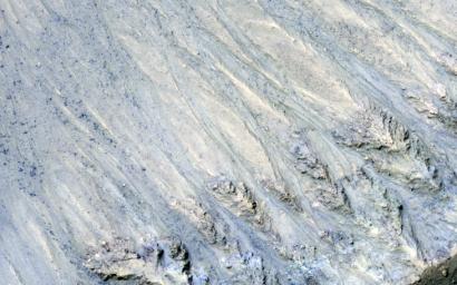 This enhanced color image from NASA's Mars Reconnaissance Orbiter (MRO) shows what are called 'recurring slope lineae' in Tivat Crater. The narrow, dark flows descend downhill (towards the upper left).