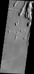 The three large aligned Tharsis volcanoes are Arsia Mons, Pavonis Mons and Ascreaus Mons (from south to north). This image from NASA's 2001 Mars Odyssey spacecraft shows part of the northeastern flank of Arsia Mons at the summit caldera.