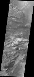 Candor Chasma is one of the largest canyons that make up Valles Marineris. This image captured by NASA's 2001 Mars Odyssey spacecraft shows part of western Candor and the erosion of a large mesa.