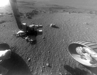 This late-afternoon view from the front Hazard Avoidance Camera on NASA's Mars Exploration Rover Opportunity shows a pattern of rock stripes on the ground, a surprise to scientists on the rover team.