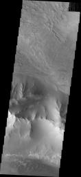 This image from NASA's 2001 Mars Odyssey spacecraft shows part of the eastern end of Ius Chasma. Geryon Montes are located in the bottom half of the image. Between the montes and the southern wall face is a region of sand and sand dunes.