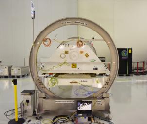 One of the two Gravity Recovery and Climate Experiment Follow-On (GRACE-FO) satellites and its turntable fixture at the Astrotech Space Operations processing facility at Vandenberg Air Force Base, California.