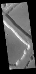 Located on the western margin of Lunae Planum, Sacra Fossae is a group of linear depressions. The right angle turns and uniform width seen in this image from NASA's 2001 Mars Odyssey spacecraft indicate that these channels were formed by faulting.