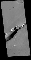 The feature that crosses this image captured by NASA's 2001 Mars Odyssey spacecraft is a graben. Graben are formed by tectonic action, where a block of material moves downward between a pair of faults.
