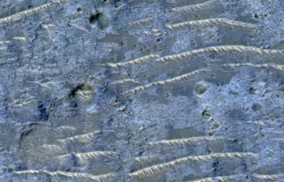 This enhanced color image from NASA's Mars Reconnaissance Orbiter (MRO) shows the heavily channeled and ancient southern highlands of Mars. The elongated and jagged features are windblown dunes, perhaps hardened and eroded.