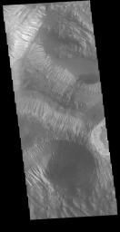 This image from NASA's Mars Odyssey is located in the center of Hebes Chasma, a large deposit of layered material called Hebes Mensa.