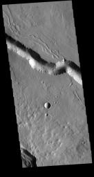 This image from NASA's Mars Odyssey shows a section of one of the many channel forms found on the northwestern side of the Elysium Mons volcanic complex. The channel features are thought to have both a tectonic and volcanic origin.