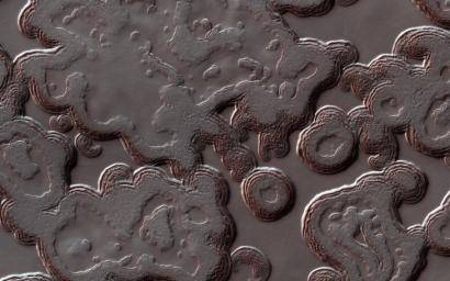 This image acquired on August 1, 2018 by NASA's Mars Reconnaissance Orbiter, shows the Martian south polar cap full of pits that make it look like Swiss cheese.