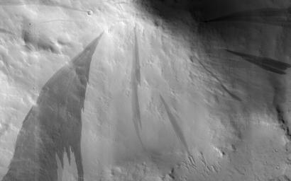 This image acquired on September 30, 2018 by NASA's Mars Reconnaissance Orbiter, shows slope streaks which are small avalanches of dust and sand from the hillsides.