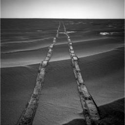 In this navigation camera raw image, NASA's Opportunity Rover looks back over its own tracks on Aug. 4, 2010.