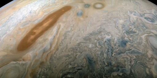 A long, brown oval known as a 'brown barge' in Jupiter's North North Equatorial Belt is captured in this color-enhanced image from NASA's Juno spacecraft.