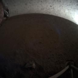 A fish-eye view of NASA's InSight lander deploying its first instrument onto the surface of Mars, taken by the spacecraft's Instrument Context Camera (ICC) on Dec. 19, 2018.