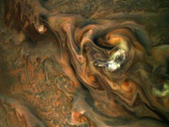 This view from NASA's Juno spacecraft captures colorful, intricate patterns in a jet stream region of Jupiter's northern hemisphere known as Jet N3.