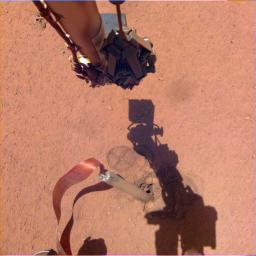 The shadow of NASA InSight's robotic arm moves over its heat probe on Nov. 3, 2019, the 333rd Martian day, or sol, of the mission.