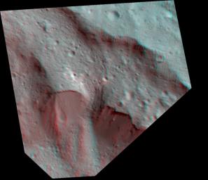 This Dawn stereo anaglyph of Occator Crater on Ceres shows impact melt deposits draped on faulted blocks on the northeastern rim of the 57-mile (92-kilometer) diameter crater.