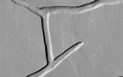 This image acquired on June 3, 2021 by NASA's Mars Reconnaissance Orbiter, shows intersecting troughs, or fractures, cutting across geologically young volcanic terrain in the Tharsis volcanic province.