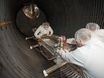 Engineers and technicians prepare NASA's COLDArm robotic arm system for testing in a thermal vacuum chamber at the agency's Jet Propulsion Laboratory in Southern California in November 2023.