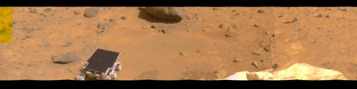 This image represents the first two tiers of a 360-degree color panorama, taken by NASA's Imager for Mars Pathfinder (IMP) on July 9, 1997. At left, the forward ramp is visible near the larger rocks.