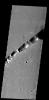 This large fracture occurs on the lava flows of Ceraunius Tholus on Mars, taken by NASA's Mars 2001 Odyssey spacecraft.