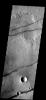 These fractures and graben are part of Sirenum Fossae on Mars as seen by NASA's 2001 Mars Odyssey spacecraft.