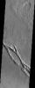 Hrad Vallis, seen in this NASA Mars Odyssey image, appears to be affecting the local wind patterns. The texture of the terrain just around the valleys is markedly different from that its surroundings.