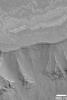 NASA's Mars Global Surveyor shows chasms and canyons cut through ancient, layered bedrock in West Candor, part of the vast Valles Marineris trough system on Mars.