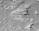 Layered rocks are seen by NASA's Opportunity rover on Feb. 9, 2004 in Opportunity Ledge. Unparallel lines give unparalleled clues that some 'moving current' such as volcanic flow, wind, or water formed these rocks.