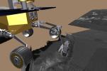 This screenshot from a computer-generated animation shows NASA's Mars Exploration Rover Opportunity's arm exploring the trench dug by one of its wheels. The rover's arm is designed to examine rocks and soil for signs of past water on Mars.