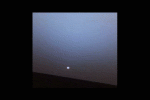 NASA's Mars Exploration Rover Opportunity watches a sunset on a martian afternoon. Rapid dimming of the Sun near the horizon is due to the dust in the sky. Dust in the martian atmosphere scatters blue light forward creating a'halo' of blueish sky color.