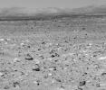 This image taken by NASA's Mars Exploration Rover's panoramic camera on April 5, 2004 shows the eastern-lying 'Columbia Hills.' Of particular interest is the light-toned coating seen here on the low-lying rocks.