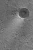 NASA's Mars Global Surveyor shows thin deposits of bright dust forming tails in the lee of craters in Acidalia Planitia on Mars.