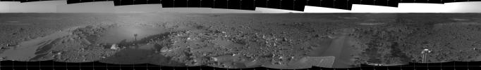 This 360-degree panorama taken by NASA's Mars Exploration Rover Spirit highlights the bumpy terrain surrounding the rover. Spirit's shadow can be seen in a small hollow lying between the rover and its intended target, the eastern-lying 'Columbia Hills.'