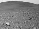 This image from the panoramic camera on NASA's Mars Exploration Rover Spirit shows scoriaceous rocks (rocks containing holes or cavities) on the ground, as well as a transition from rocky terrain (foreground) to smoother terrain (background).