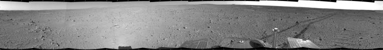 This cylindrical-projection mosaic was created from images that NASA's Mars Exploration Rover Spirit acquired May 6, 2004. Continuing its trek toward the 'Columbia Hills,' Spirit broke its record for the longest distance traveled in one Martian day.