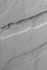 NASA's Mars Global Surveyor shows troughs and a pit chain (on the floor of the deeper trough) located immediately northeast of the giant Tharsis volcano, Arsia Mons on Mars.