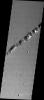This image released on Nov 11, 2004 from NASA's 2001 Mars Odyssey shows collapse pits found within the extensive lava flows of the Tharsis region on Mars. They are related to lava tubes, likely coming from Ascraeus Mons.
