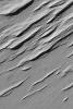 NASA's Mars Global Surveyor shows a suite of yardangs in the Memnonia Sulci region on Mars. Yardangs are ridges formed by wind erosion. Most commonly, they will form in sedimentary rocks or volcanic ash deposits containing some amount of sand-size grains.