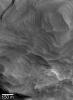 NASA's Mars Global Surveyor shows finely-layered sedimentary rock in a crater in northwestern Schiaparelli basin on Mars.
