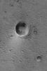 NASA's Mars Global Surveyor shows an impact crater and associated bright wind streak in Acidalia Planitia on Mars. Dozens of smaller craters dot the scene.