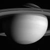 Far above the howling winds of Saturn, its icy moons circle the planet in silence. This image from NASA's Cassini spacecraft shows Mimas near the upper right, while Tethys hovers at the bottom.