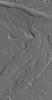 NASA's Mars Global Surveyor shows channels carved into the plains mantled with dust southeast of the large volcano, Olympus Mons on Mars.