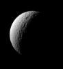NASA's Cassini spacecraft surveys the ancient, craggy surface of Tethys, sighting the crater Telemachus with its prominent central peak.