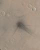 NASA's Mars Global Surveyor shows the north flank of the Martian volcano Ulysses Patera on Mars. Fine details are evident at the impact site, showing how the blast moved dust around and interacted with craters and other small obstacles on the ground.