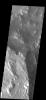 This image from NASA's Mars Odyssey spacecraft shows a small crater bordering the much larger Oudemans Crater. The long landslide could have occurred during the formation of the small crater.
