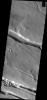 This image from NASA's Mars Odyssey shows linear depressions created by fault action. These features are located on the western margin of the Elysium Volcanic Complex.